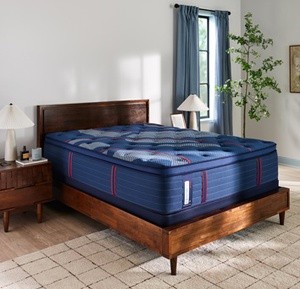 A Posturepedic Elite Spring mattress in a styled room
