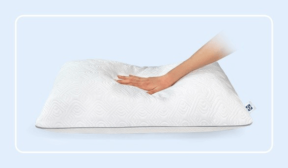 A hand pressing on a Sealy adjustable pillow with a rounded white border