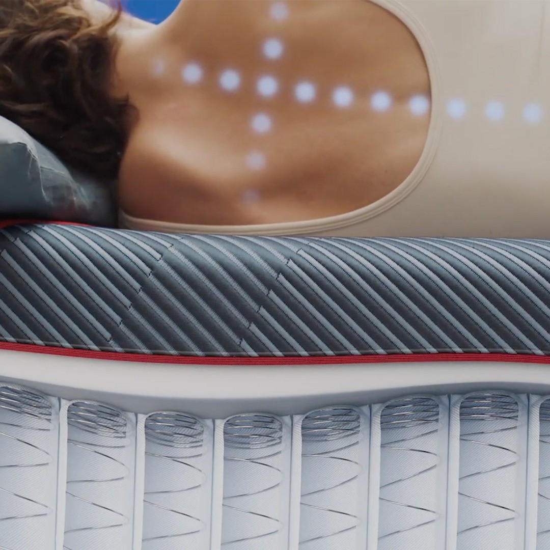 of a womans back displaying the support of the exclusive coil providing support