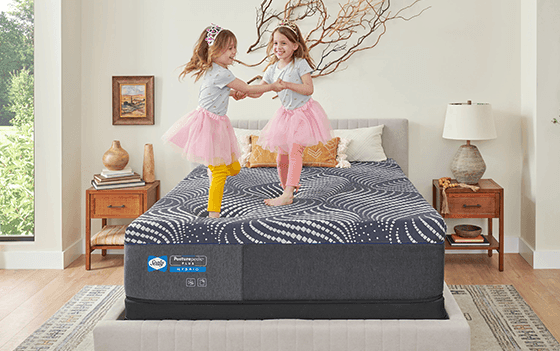 Girls jumping on Posturepedic Plus mattress