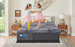 Girls jumping on Posturepedic Plus mattress