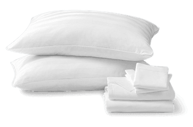Two white pillows and sheet set stacked next to each other